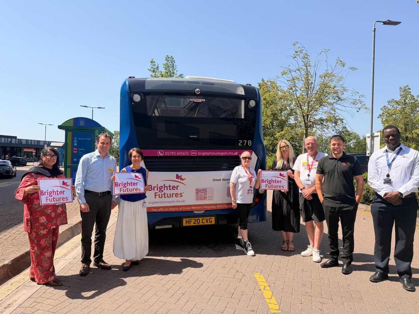 Brighter Futures charity bus with charity and Swindon's Bus Company representatives